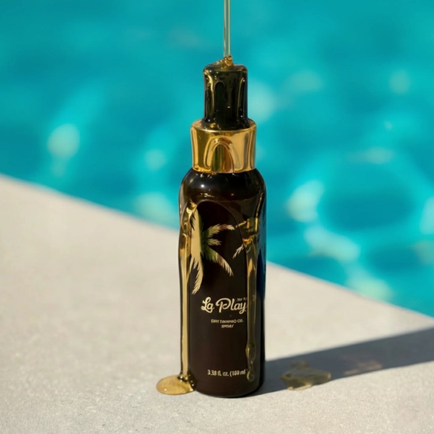 Onyx La Playa Dry Tanning Oil Spray bottle standing by a swimming pool with golden oil dripping onto the surface.