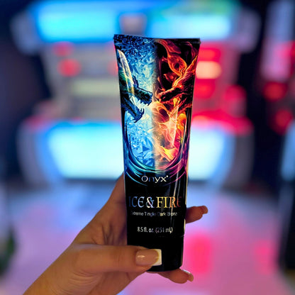 Hand holding Onyx Ice & Fire Extreme Tingle Dark Bronzer in front of colourful tanning lights.