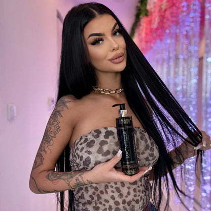 Model holding an Onyx Magnifique tanning lotion bottle cream, with decorative flowers in the background.