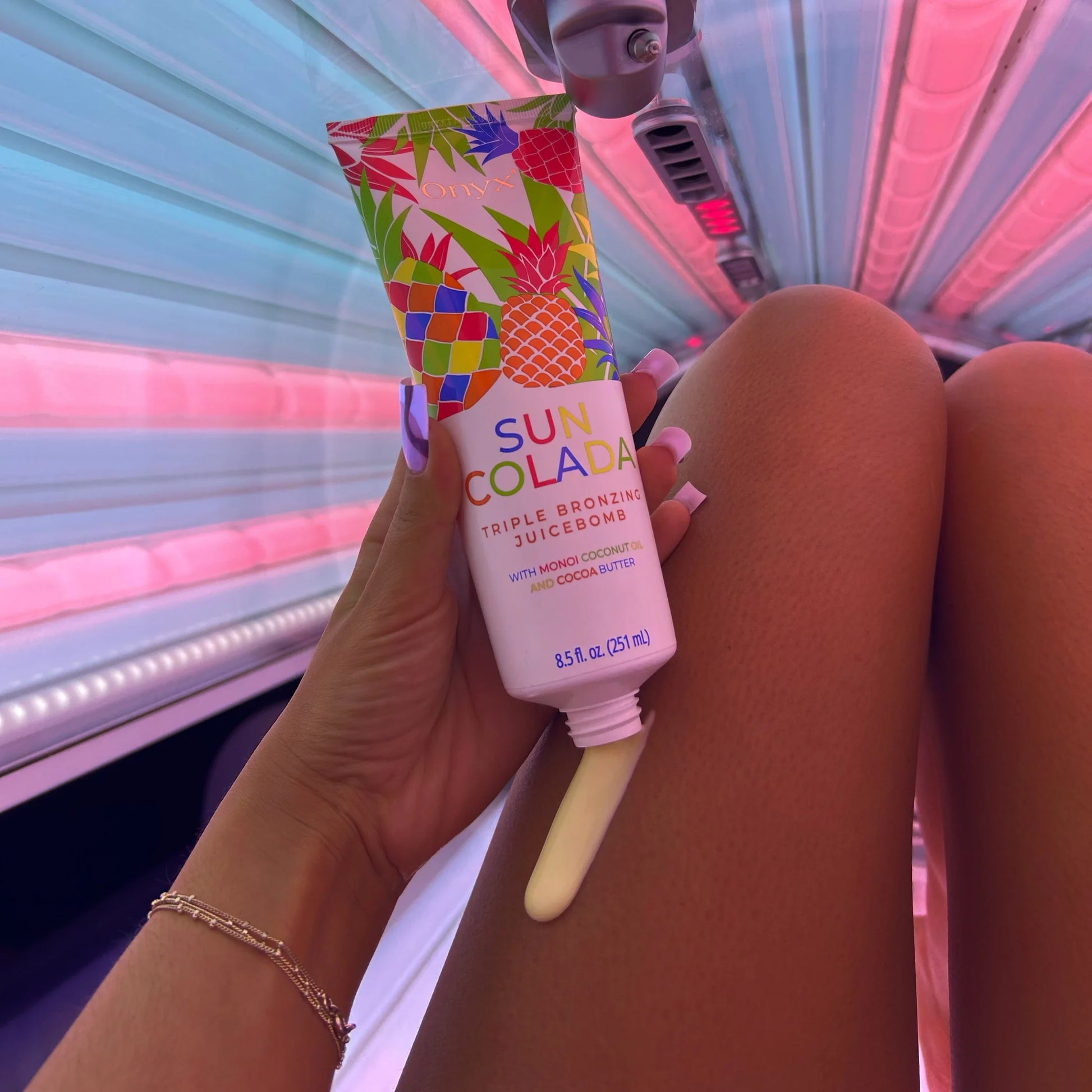 Onyx Suncolada sunbed accelerator cream applied to leg inside sunbed