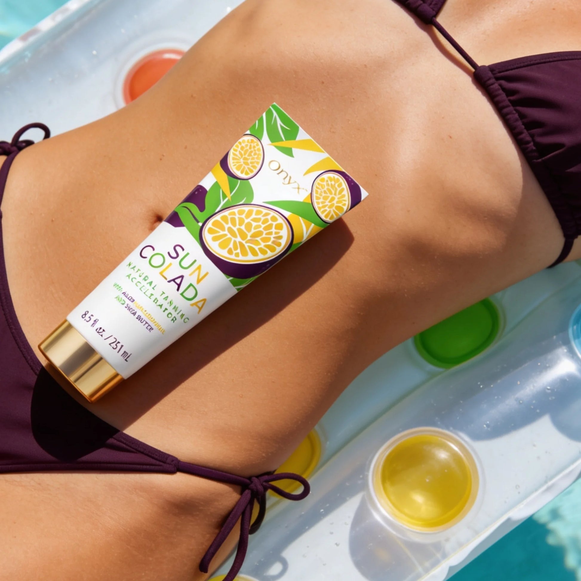 Onyx Suncolada Natural Tanning Accelerator cream tube placed on a model’s midsection while relaxing on an inflatable float in the water.